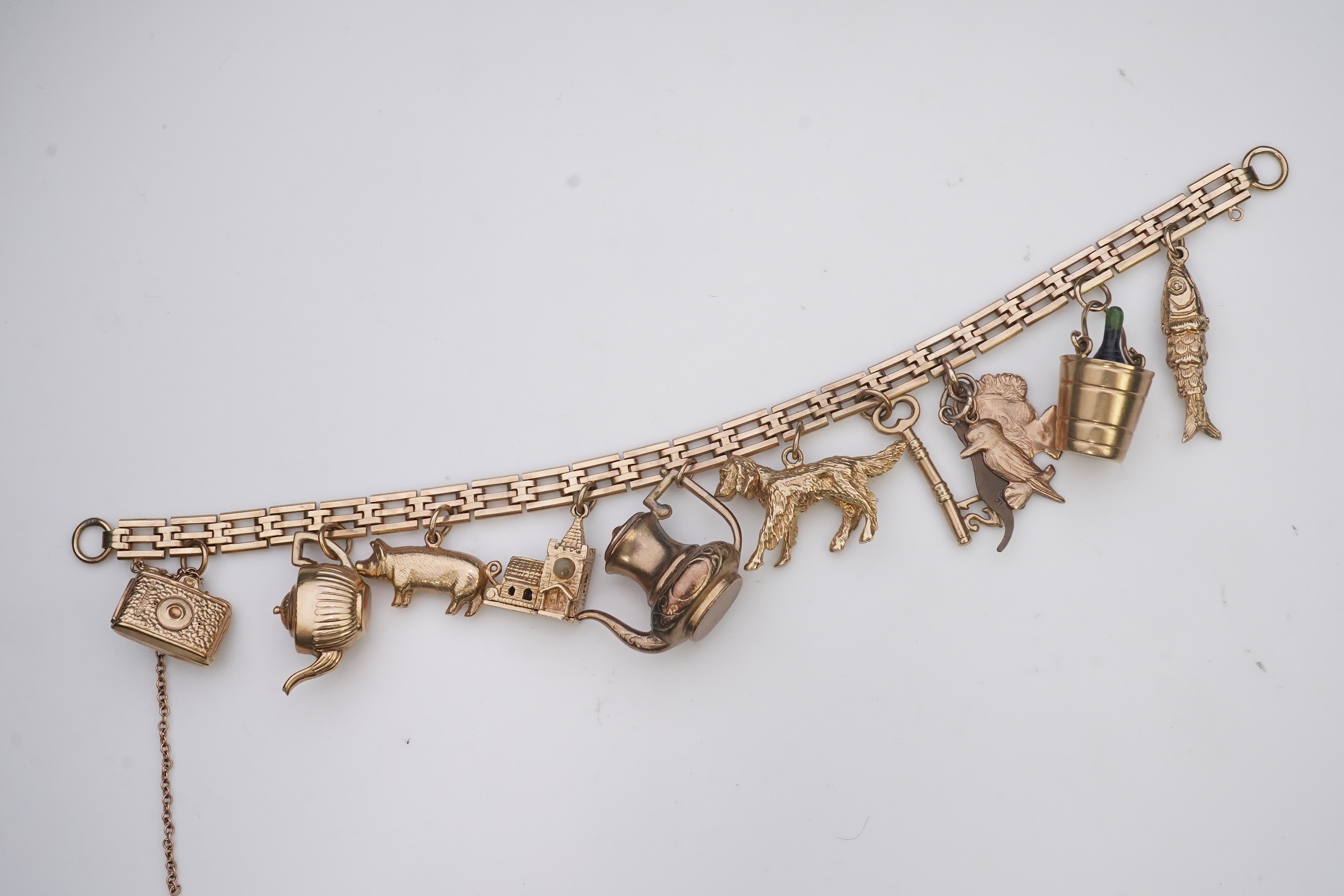 A charm bracelet, mid 20th century